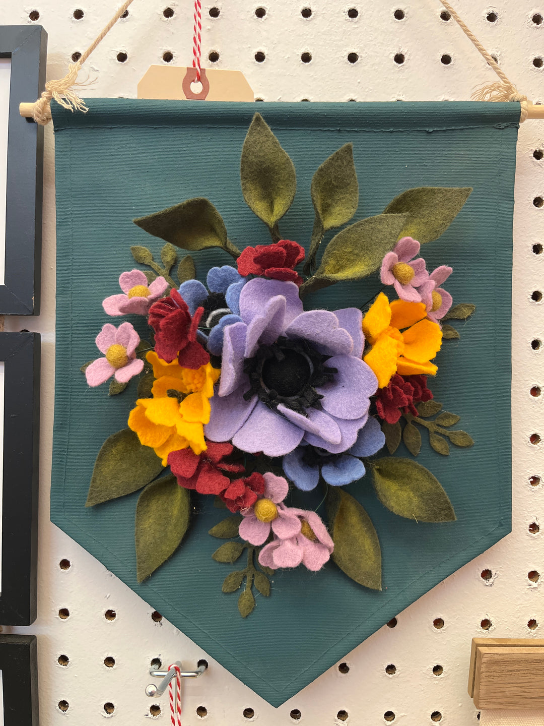 dark teal wall hanging with felt flowers