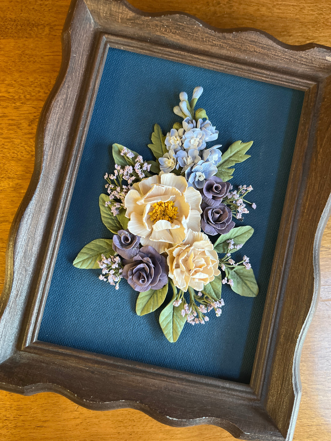 dark brown wood framed clay flowers