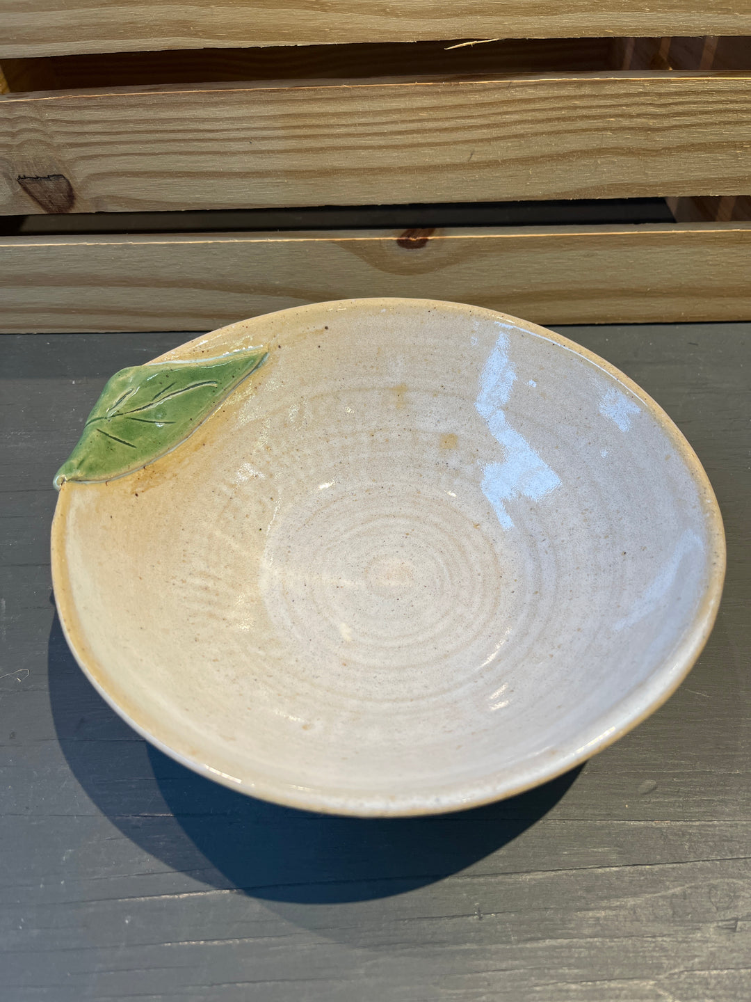 White stoneware with green leaf